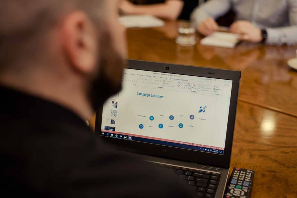 Sprint Digital team member at meeting with laptop