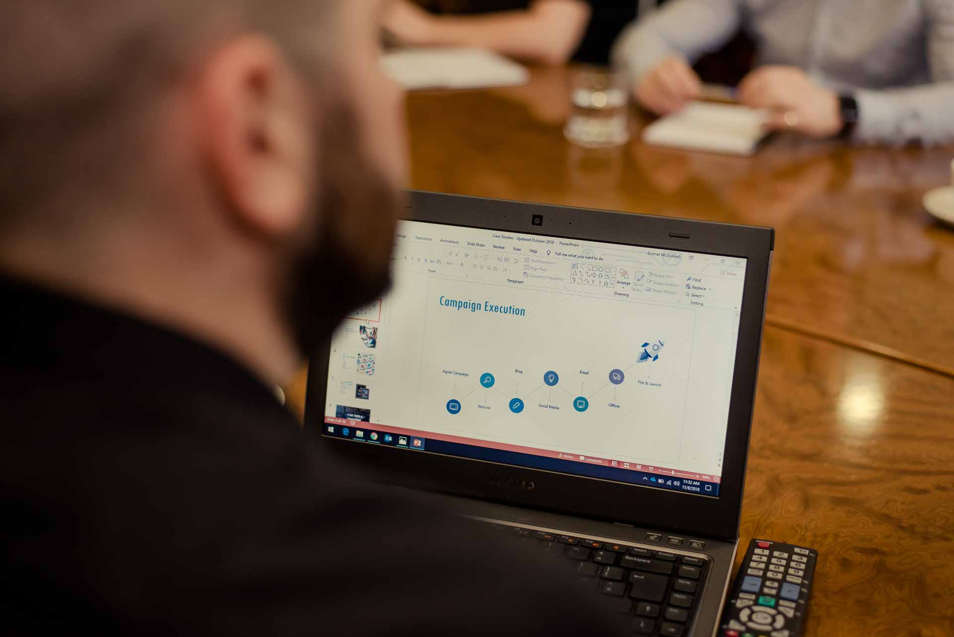 Sprint Digital team member at meeting with laptop