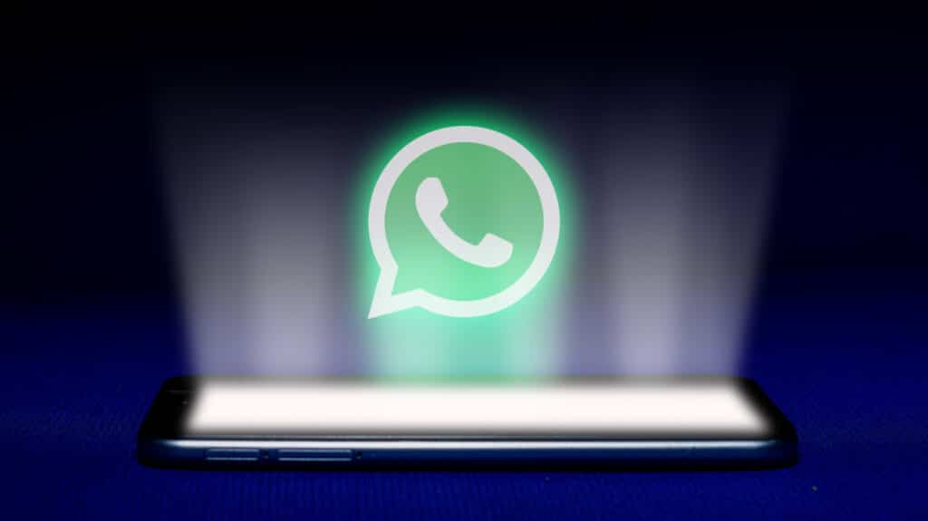 Phone beaming light of WhatsApp logo